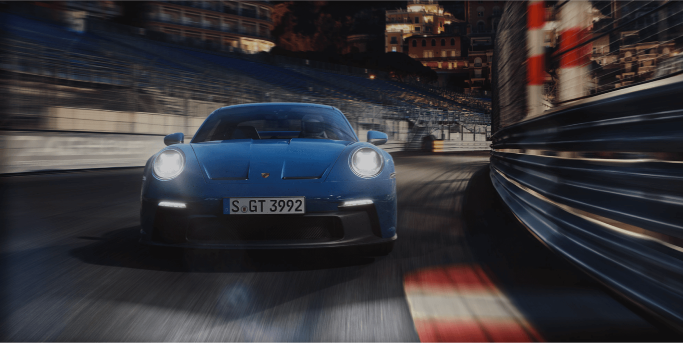 A blue porsche gt3 driving on a race track.