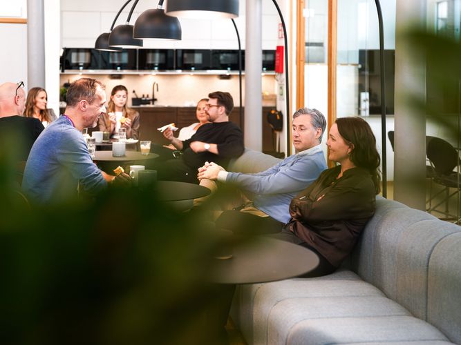 A group of people sitting around a table in an office.